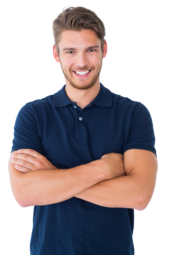 Handsome young man smiling with arms crossed on white background